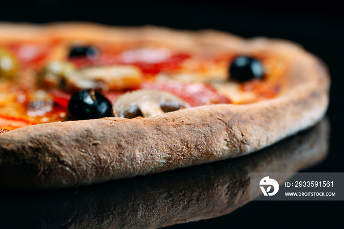 pizza with sausage, mushrooms, cheese and pepper close-up.