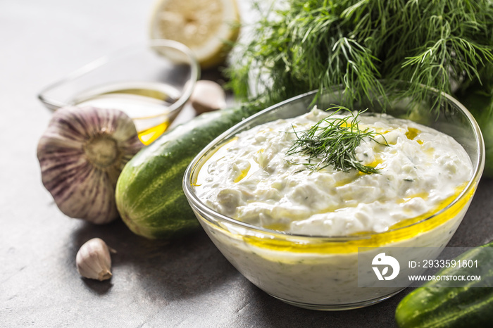 Tzatziki sause in a glass bowl dill cucumber olive oil lemon and garlic