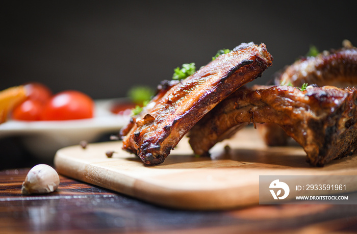 bbq pork ribs grilled with tomatoes ketchup and herbs spices served on the table - Roasted barbecue pork spare rib sliced