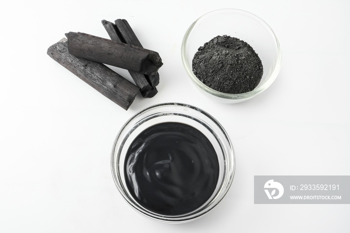 Facial mask and scrub by activated charcoal powder on white background