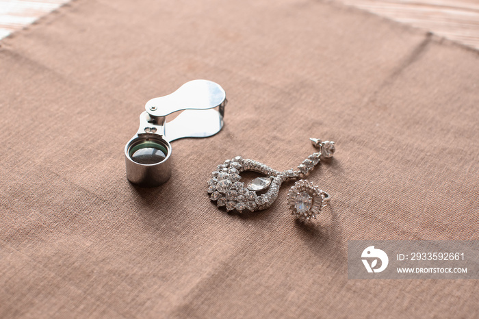 Jewelry and magnifier on table in workshop