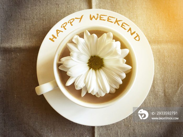 coffee cup on table with white daisy - Happy weekend word