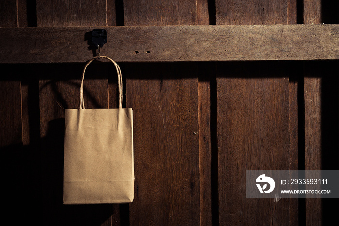 Shopping bag hanging on the wooden wall