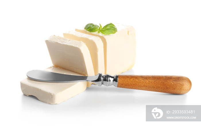 Delicious butter pieces with shovel and  basil leaves on white background, closeup