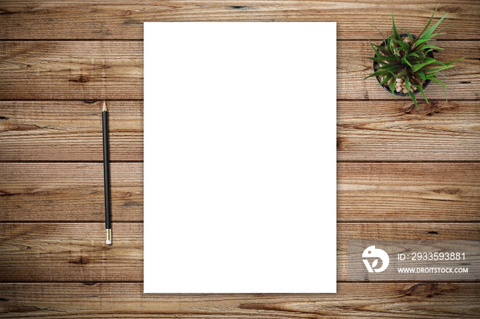 Top view of blank paper page on wood background office desk with different objects. Minimal flat lay style