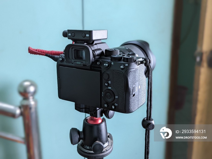 A black dslr camera on a tripod