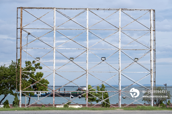 Blank steel billboard structure for outdoor advertising poster or advertisement in front of a seascape