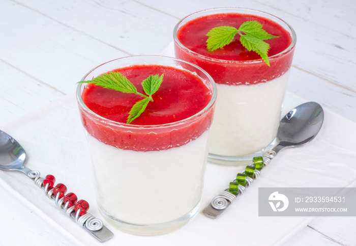 pana cotta in glasses with strawberry sauce on a white background