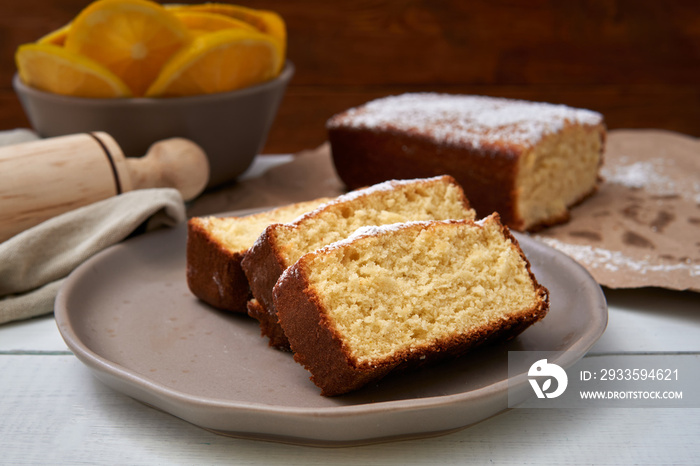 Orange spongecake made with butter and powdered sugar in the top freshly baked.