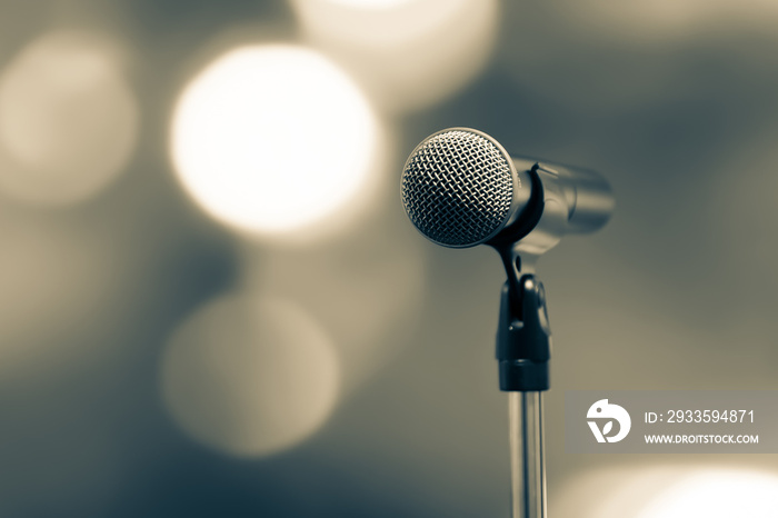 Public speaking backgrounds, Close-up the microphone on stand for speaker speech presentation stage performance with blur and bokeh light background.