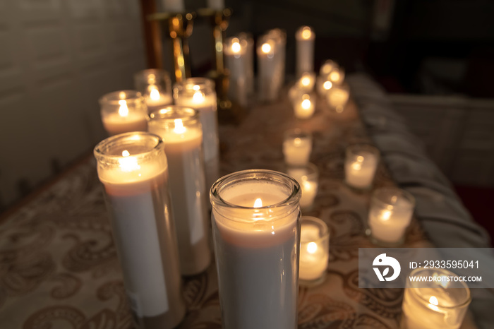 Burning candles on church altar