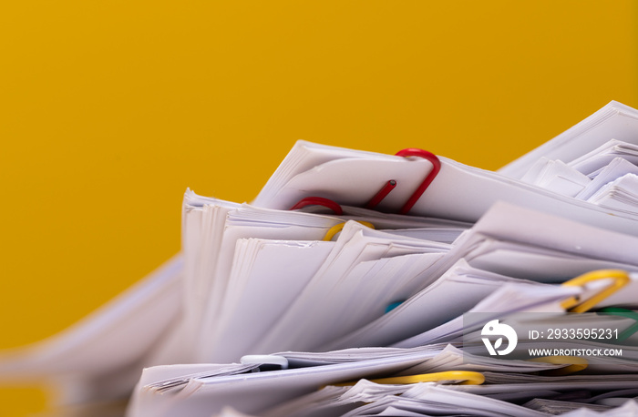 Stack of Group report papers Document on yellow background.