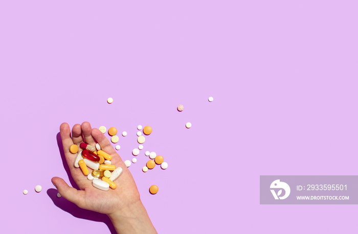 Various pills lying in a hand, overhead view