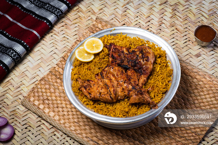 Arabian Kabsa Chicken rice with lemon slice served in dish top view of middle east food