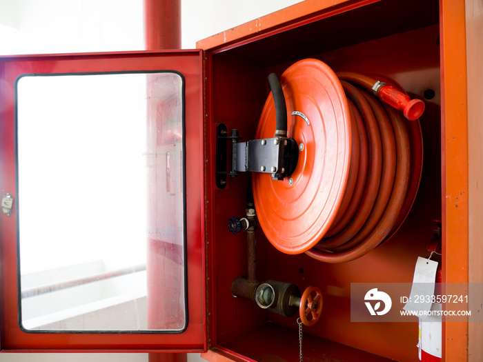 Fire extinguisher with various types of fire extinguishers Located In the white wall. copy space for text and content