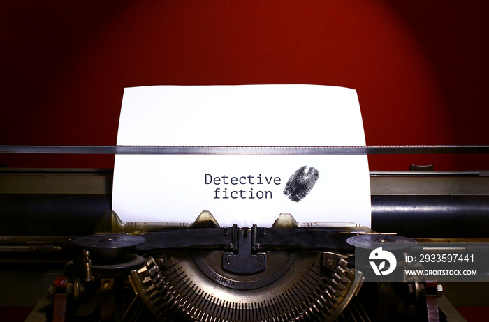 Typewriter spelling detective fiction on paper with finger print