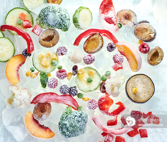 Background of frozen sliced vegetables on ice. Stocks of food consept. Top view.