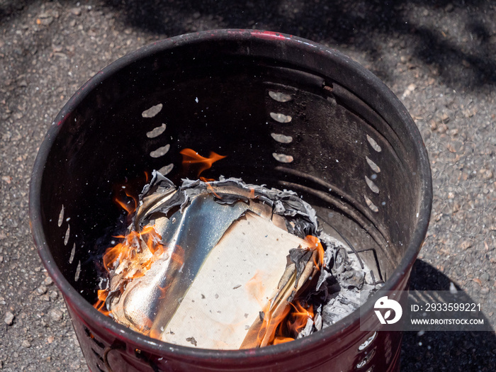 Silver Chinese joss paper being burnt for ancestral worship or prayer purposes