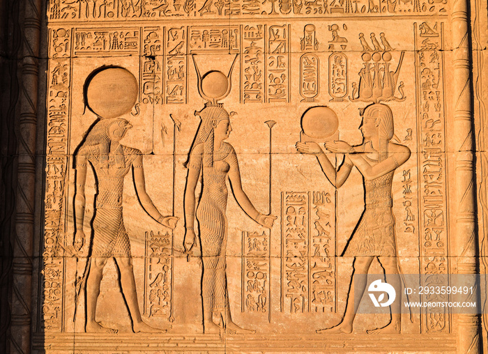 Emperor Trajan handing mirror to Hathor and Khonsu at Dendera Temple iin Egypt.