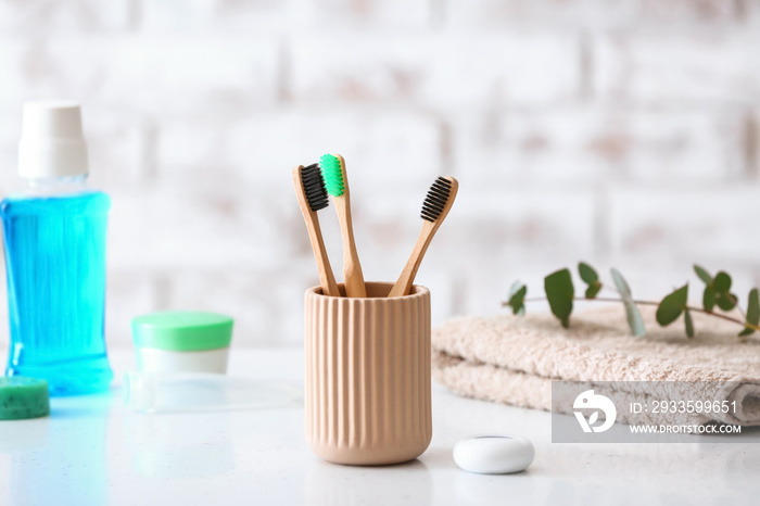 Tooth brushes in holder on table in bathroom