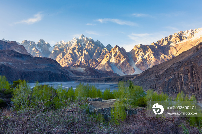 Tupopdan mountain also known as Passu Cones or Passu Cathedral, big rocks all over the place and blue crystal of Hunza river at sunset time ,Northern of Pakistan