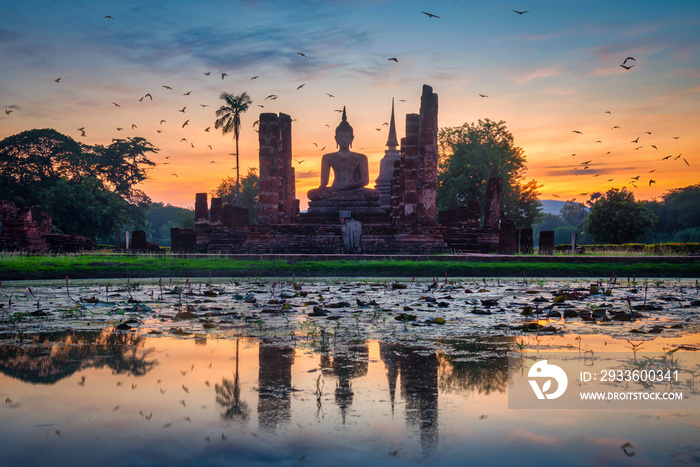 Big Buddha at sunset in Wat Mahathat temple, Sukhothai Historical Park, Thailand.