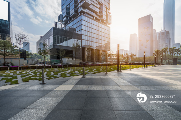 empty pavement and modern buildings in city.