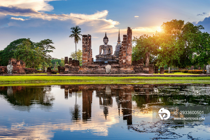 Buddha statue and Wat Mahathat Temple in the precinct of Sukhothai Historical Park, Wat Mahathat Temple is UNESCO World Heritage Site, Thailand.