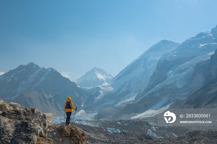 Male backpacker enjoying the view on mountain walk in Himalayas. Everest Base Camp trail route, Nepal trekking, Himalaya tourism.