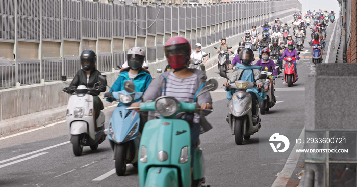 Taiwanese people ride motorcycles on the ramp of Taipei Bridge