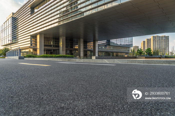 city empty traffic road with office building in background