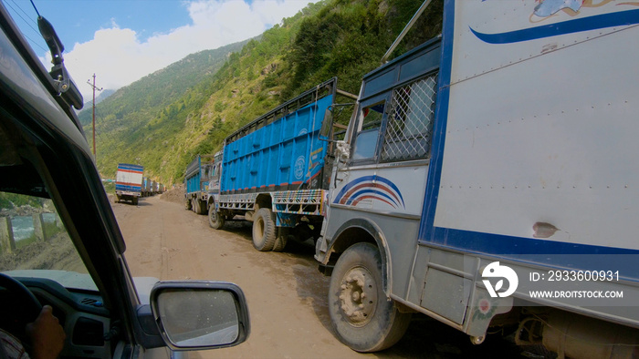 POV: Driving along an endless queue of cargo trucks waiting to cross the border