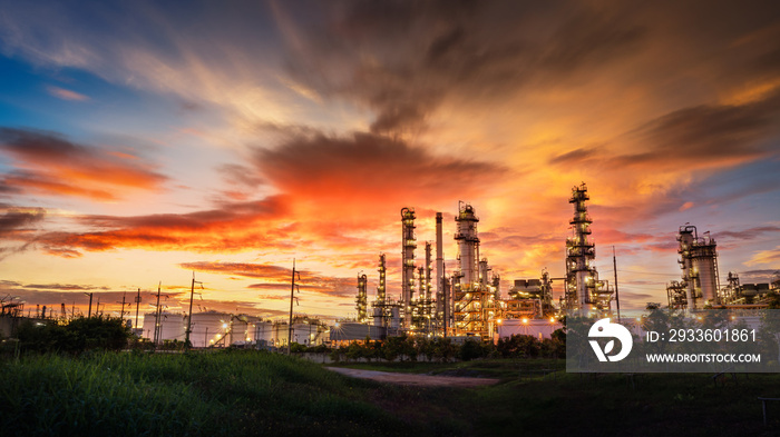 Chemical oil refinery plant, Power plant and metal pipe on red sunrise sky background.