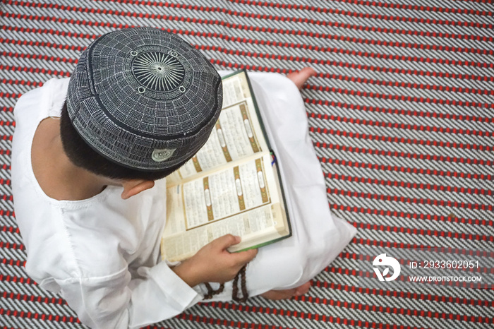 Boy reading Quran.