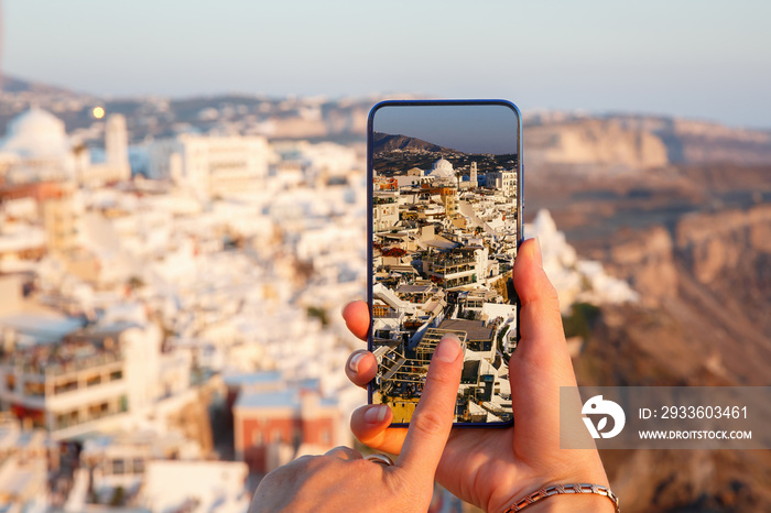 Making photos via mobile phone at Santorini island, Greece.