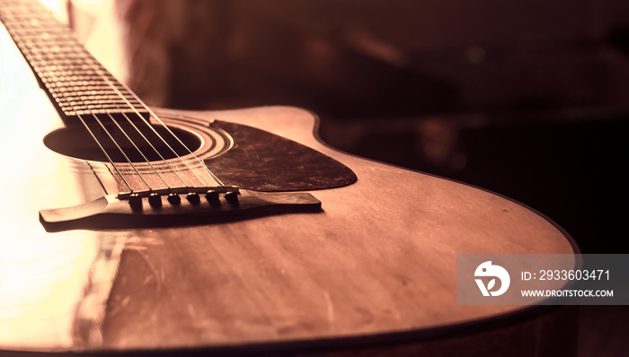 acoustic guitar close-up on a beautiful colored background