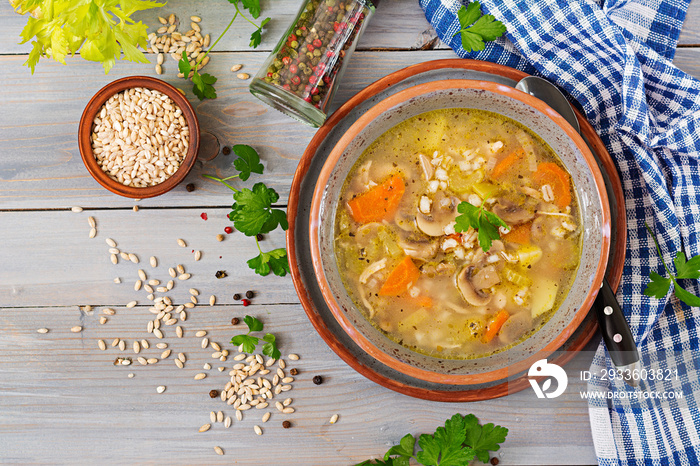 Thick soup with pearl barley, celery, chicken, and mushrooms. Dietary menu. Top view