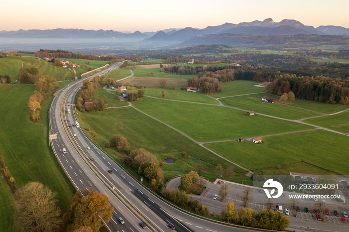 Top down aerial view of freeway interstate road with moving traffic cars in rural area.