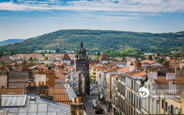 View from the top of the belfry on the Clock tower street, the Notre-dame du Marthuret and the roofs of the small town of Riom in Auvergne (France)