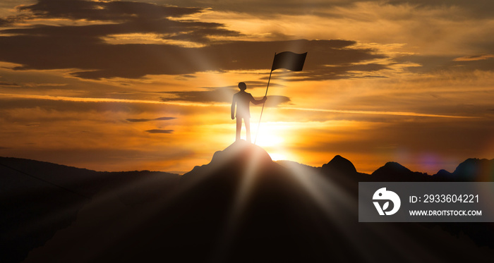 Man Standing On The Top Of Mountain Holding Flag Outdoor