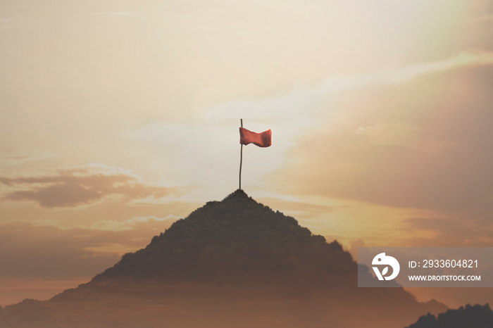 flag planted on top of a mountain, success concept