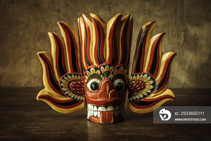 Wooden Indian red demon mask on wooden table