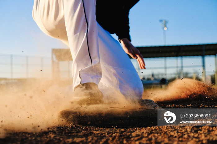 Baseball player sliding into base, sports action with athlete.