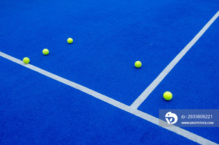 padel tennis balls on a blue court, racket sports concept