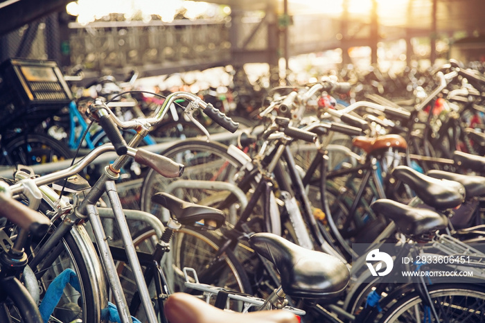 Blurred background of different bicycles in the parking lot, rainy day. Parked bicycles in Amsterdam