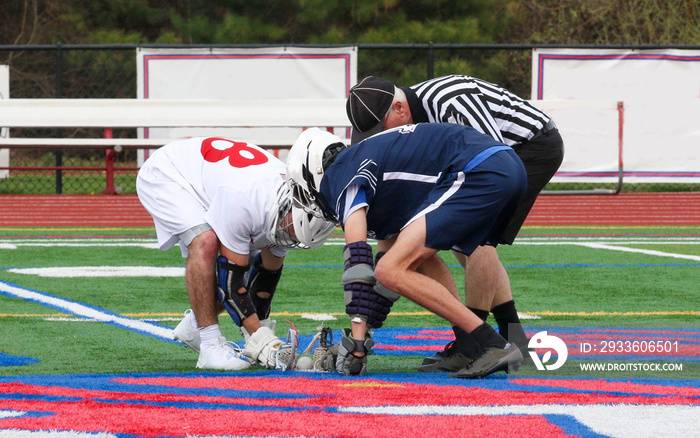 Boys Lacrosse faceoff at midfield during a high school game