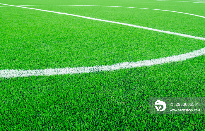 Artificial green grass with white stripe  on sports fields for soccer and football.