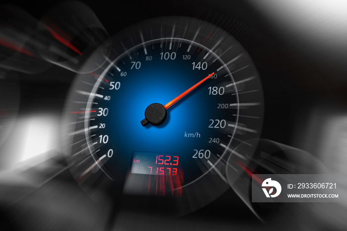 The speedometer of a modern car shows a high driving speed. Added motion blur.