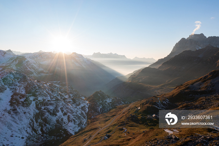 Amazing sunset in the alps of Switzerland. Wonderful flight with a drone over an amazing landscape in the canton of Uri and Glarus. Epic view over a street called Klausenpass.