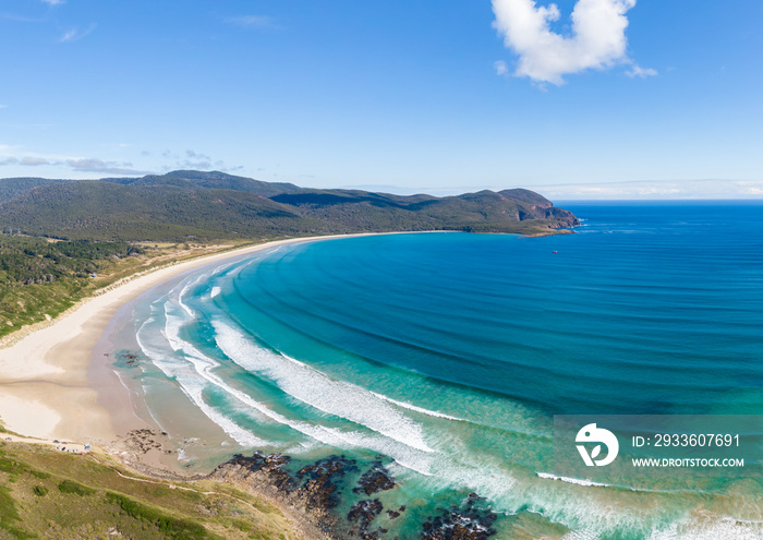 Stunning panoramic high angle aerial drone view of Cloudy Bay Beach on South Bruny, Bruny Island, Tasmania, Australia on a sunny summer day. The beach is a popular tourist destination.